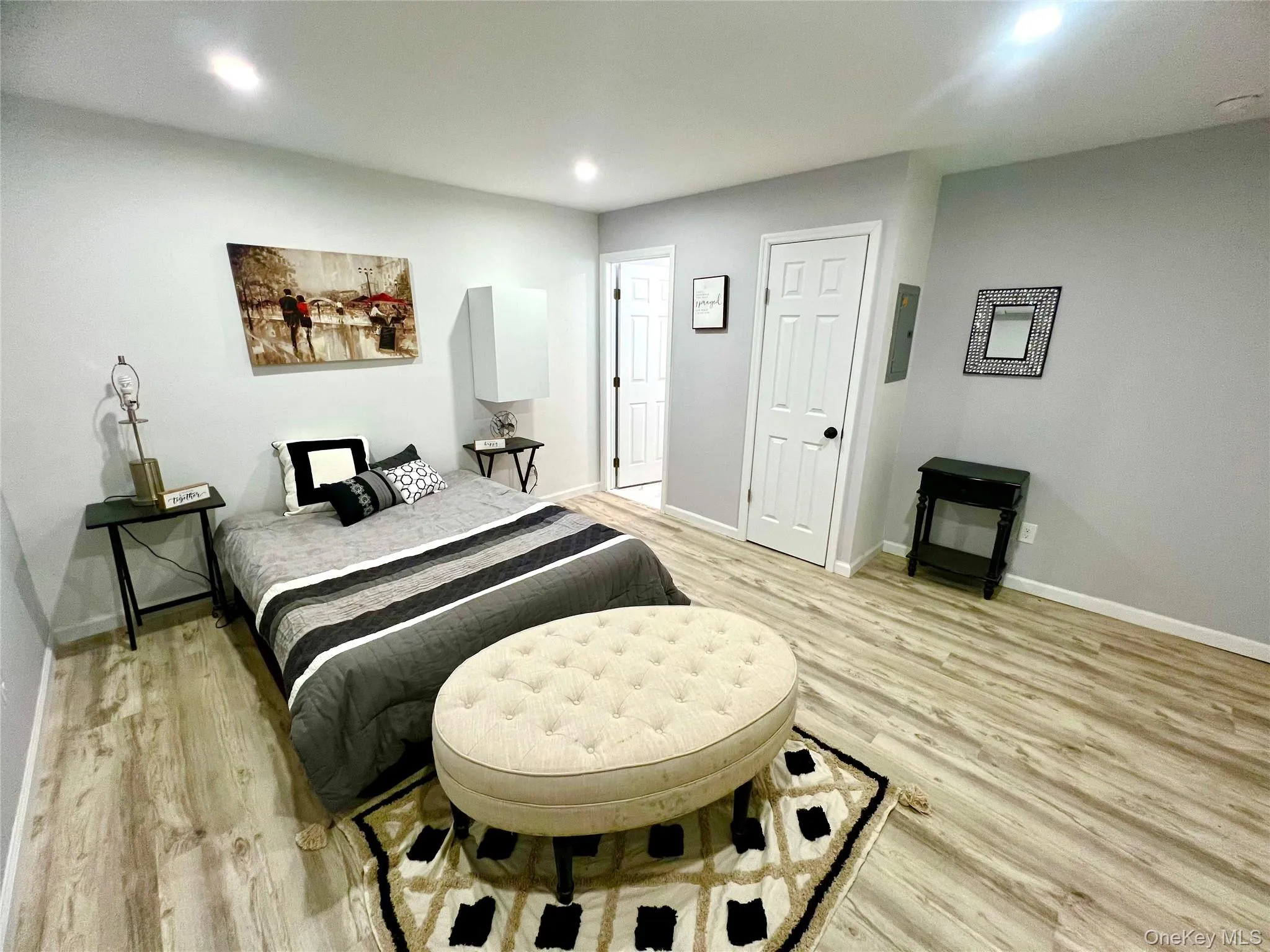 Bedroom with light wood-style floors and recessed lighting Bedroom with light wood-style floors and recessed lighting