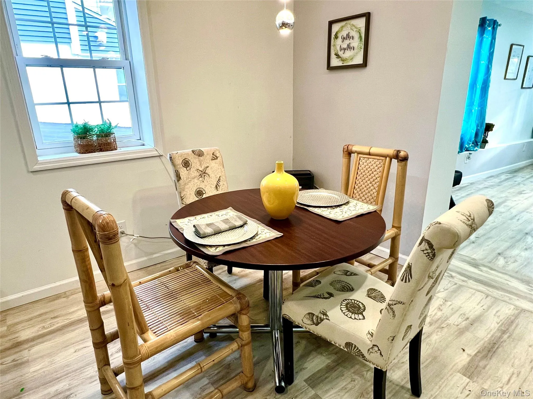 Dining area featuring baseboards and light wood-style flooring Dining area featuring baseboards and light wood-style flooring