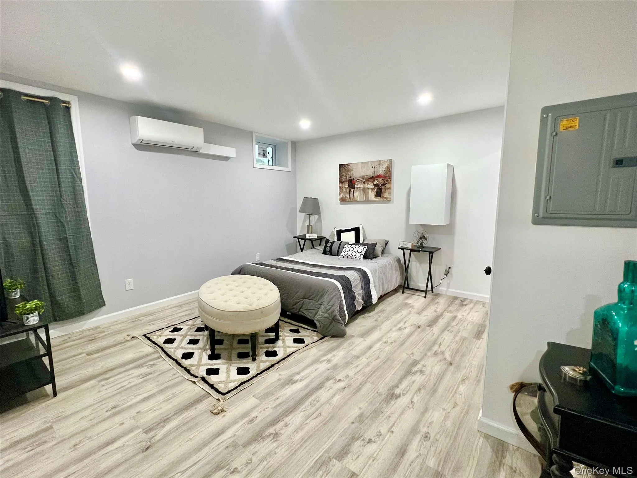 Bedroom with electric panel, light wood-style floors, and recessed lighting Bedroom with electric panel, light wood-style floors, and recessed lighting