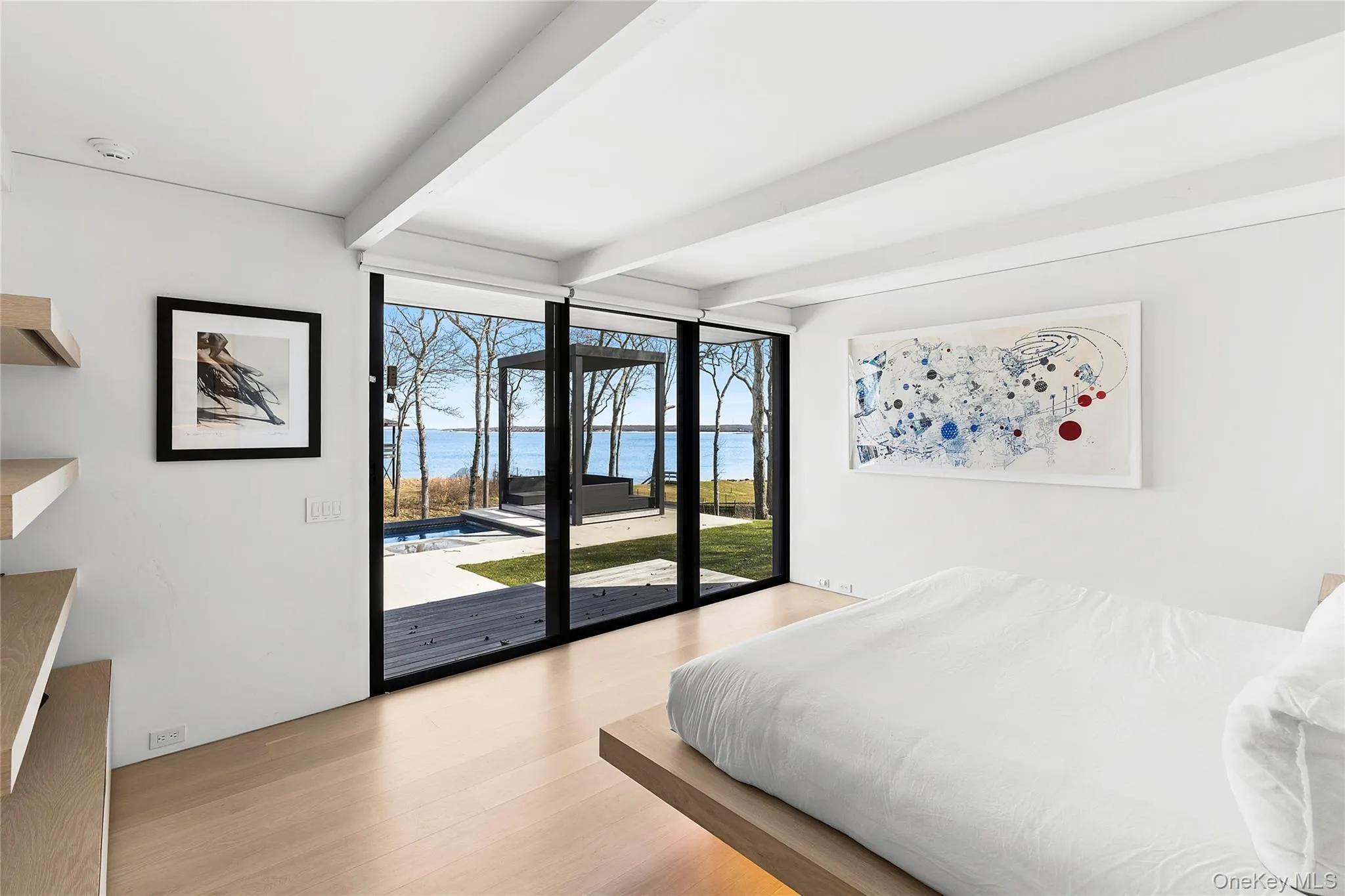Ensuite primary bedroom with water views Ensuite primary bedroom with water views
