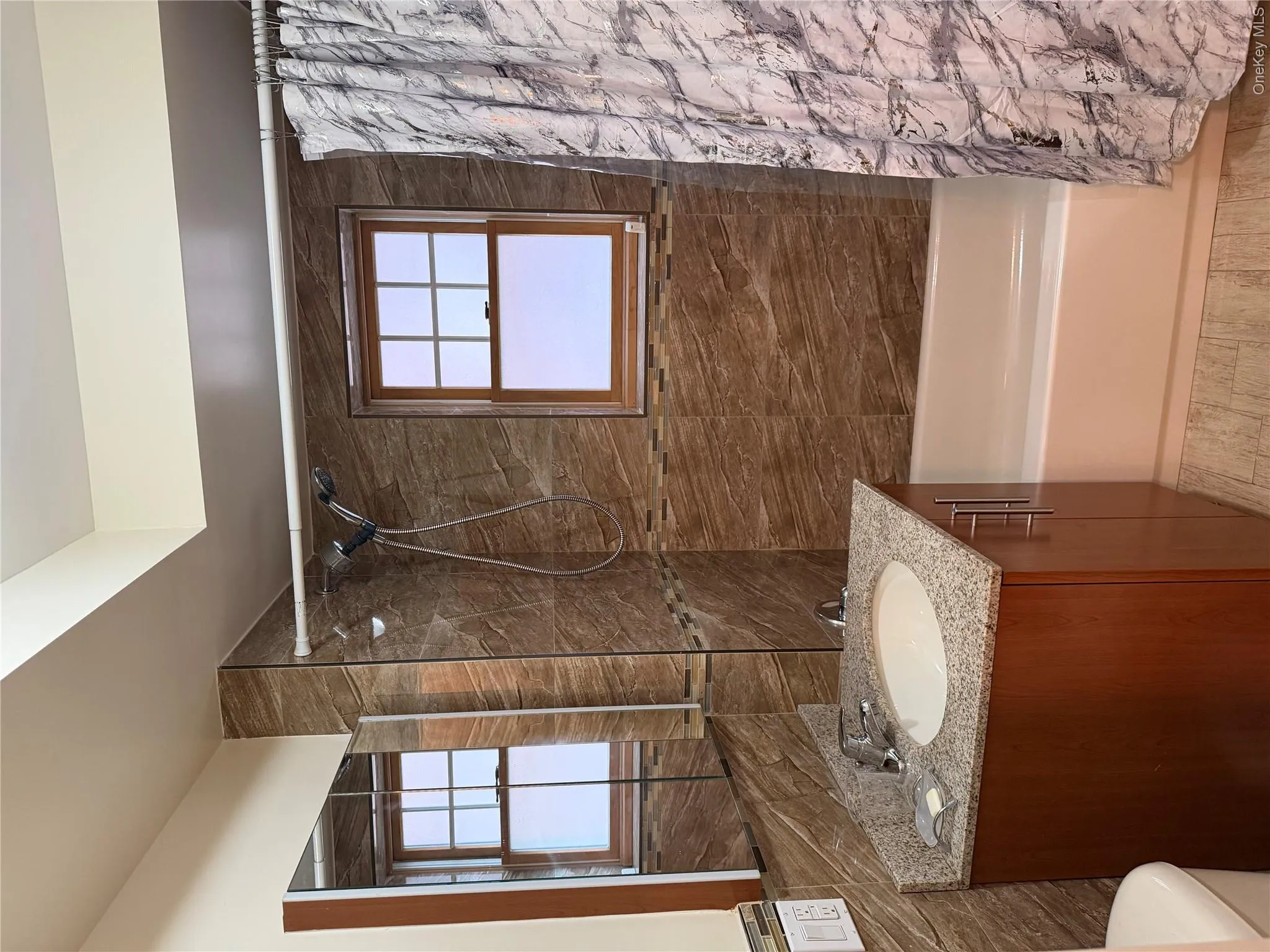Full bathroom featuring a wood-finish vanity with granite countertop and integrated sink Full bathroom featuring a wood-finish vanity with granite countertop and integrated sink
