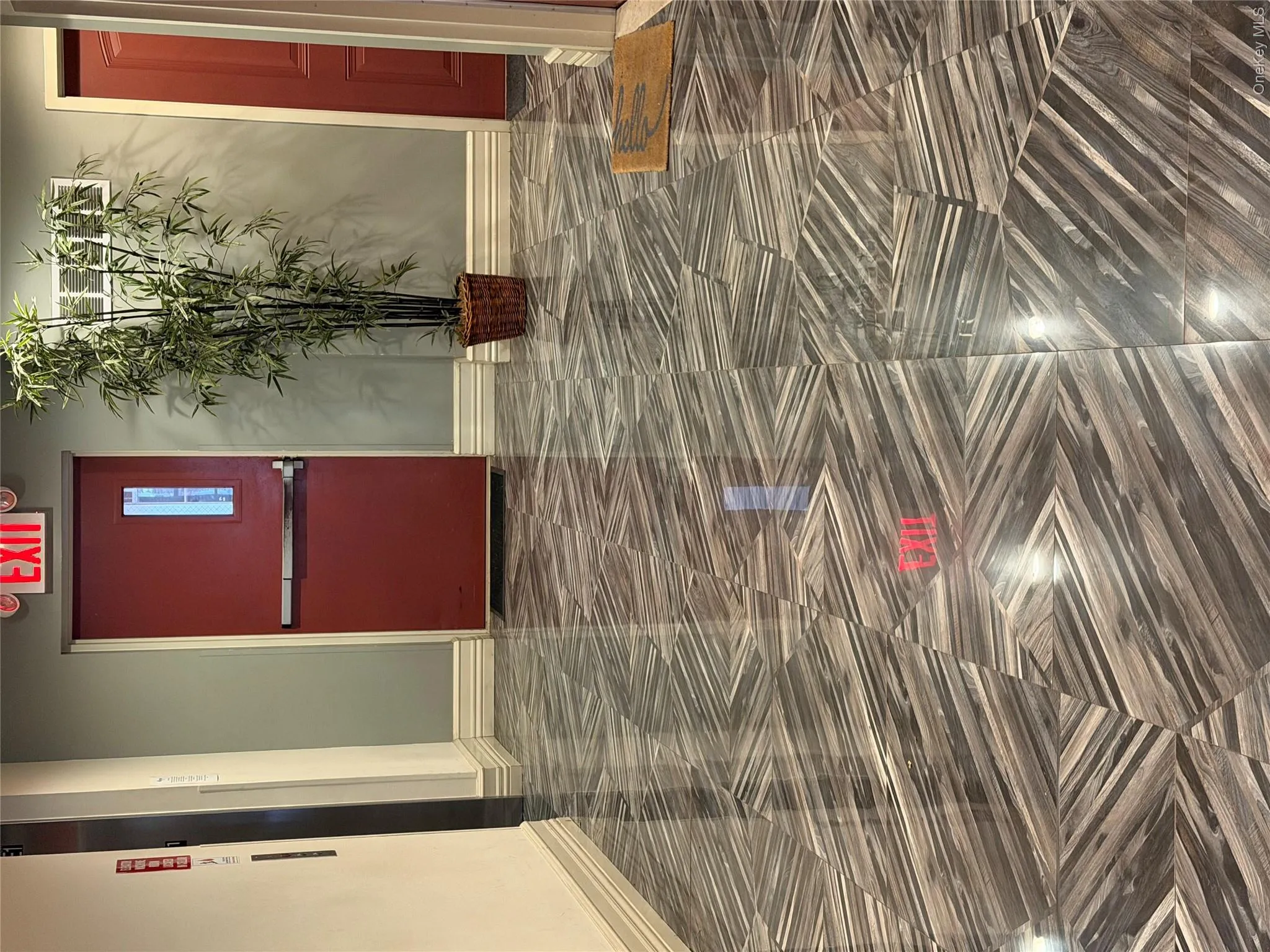 Hallway featuring patterned tile flooring Hallway featuring patterned tile flooring