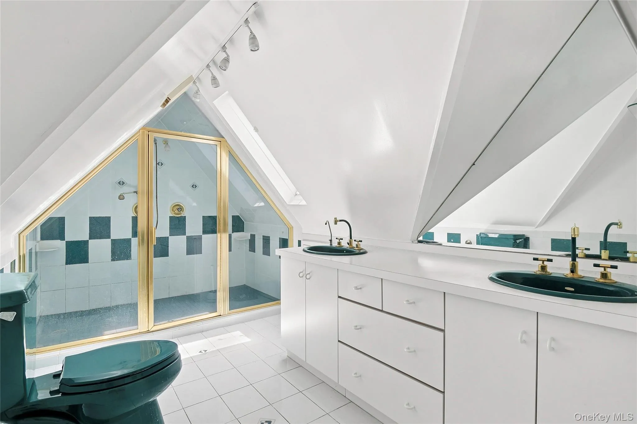 Third Floor Sloped ceiling bathroom featuring a glass-enclosed shower with gold-tone framing and checkered wall tiling Third Floor Sloped ceiling bathroom featuring a glass-enclosed shower with gold-tone framing and checkered wall tiling