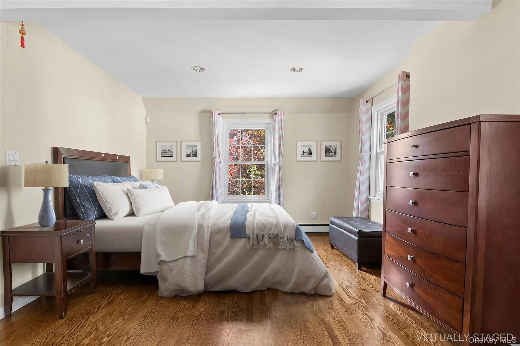 Virutally Staged Primary Bedroom with wood-finish flooring, recessed lighting, and two windows double-hung windows Virutally Staged Primary Bedroom with wood-finish flooring, recessed lighting, and two windows double-hung windows