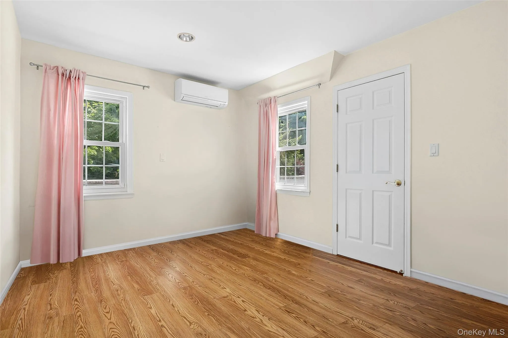 Bedroom One Featuring Hardwood Floors, two double hung windows, split AC and recessed lighting Bedroom One Featuring Hardwood Floors, two double hung windows, split AC and recessed lighting
