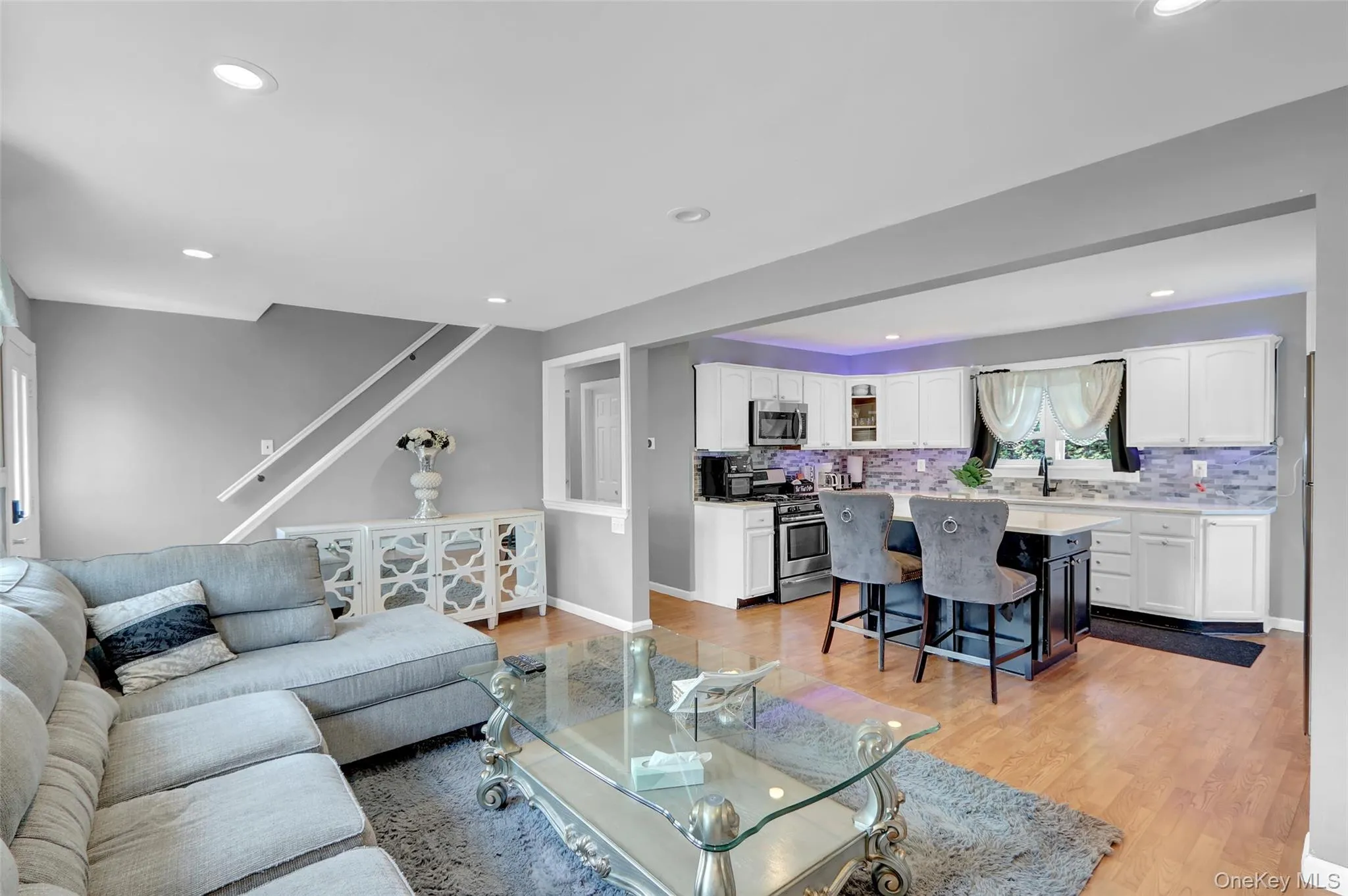 Open concept living area with wood-finish flooring Open concept living area with wood-finish flooring