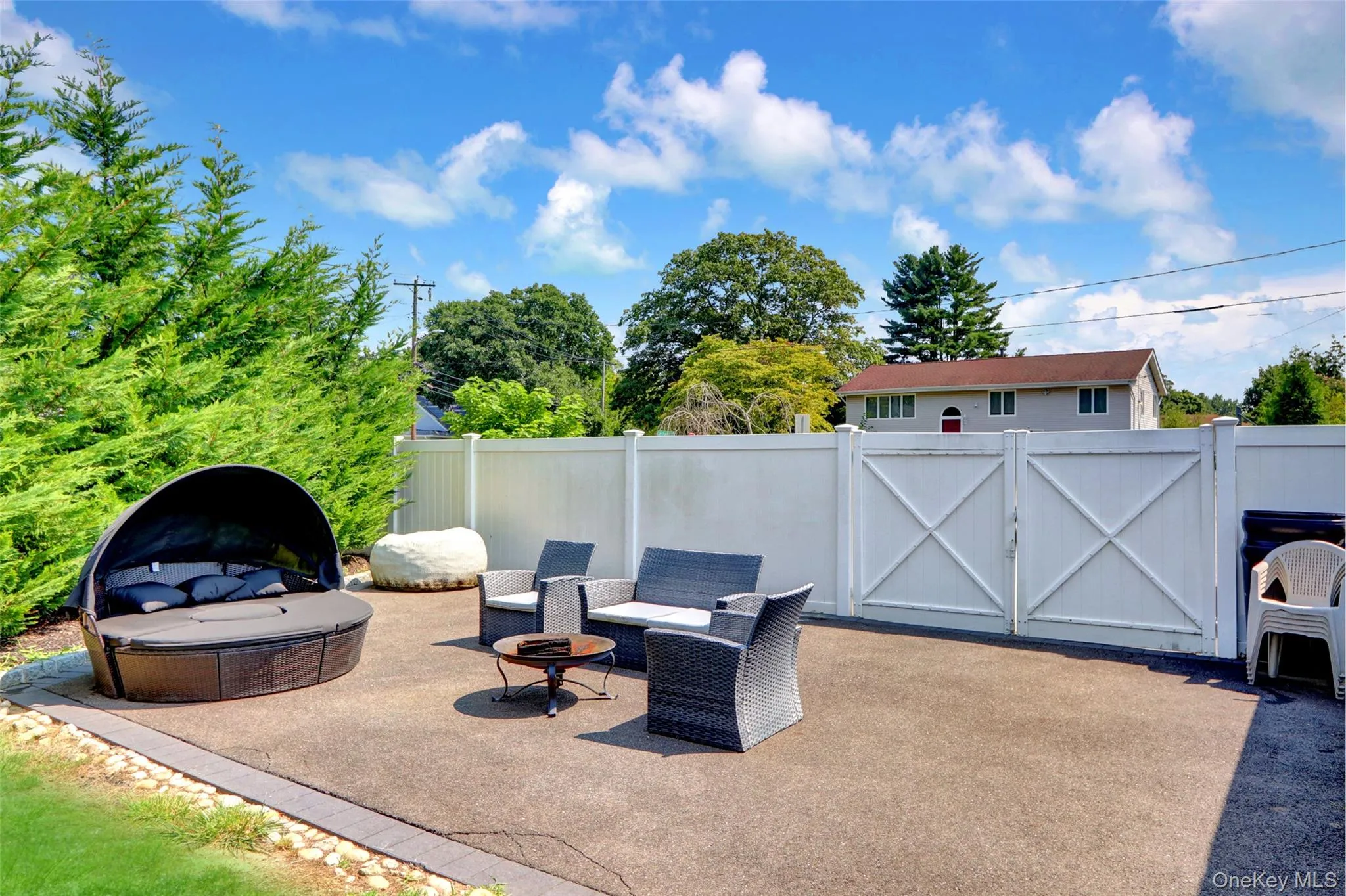 Expansive concrete patio with a full privacy fence Expansive concrete patio with a full privacy fence