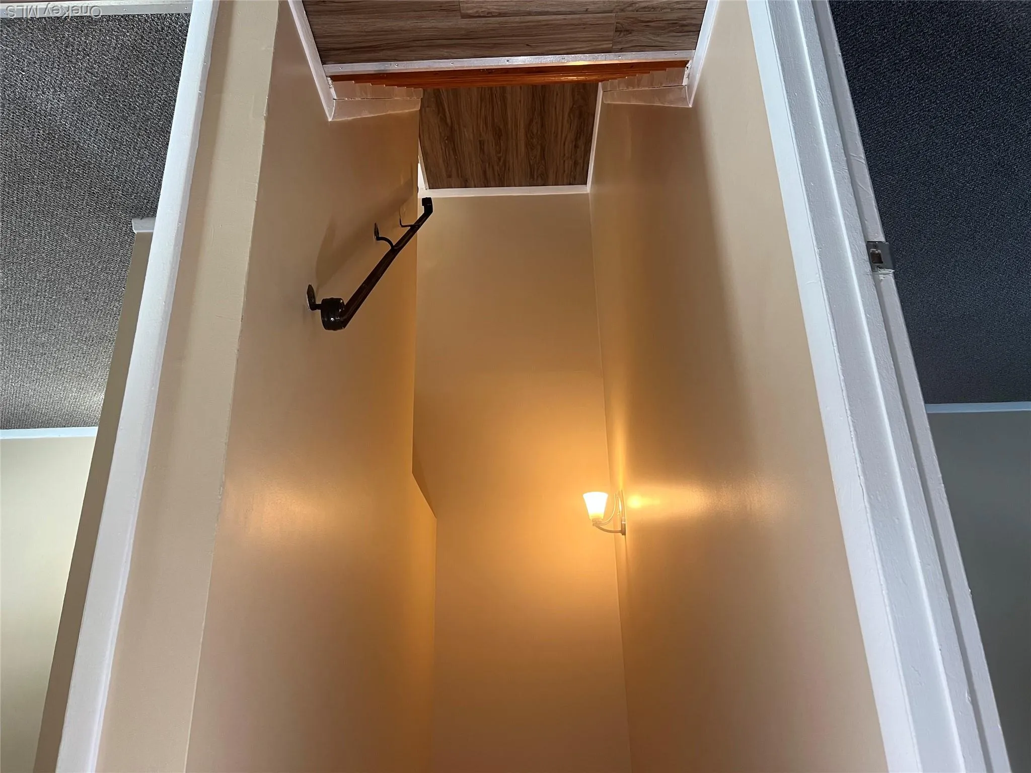 Stairs featuring baseboards and wood finished floors Stairs featuring baseboards and wood finished floors