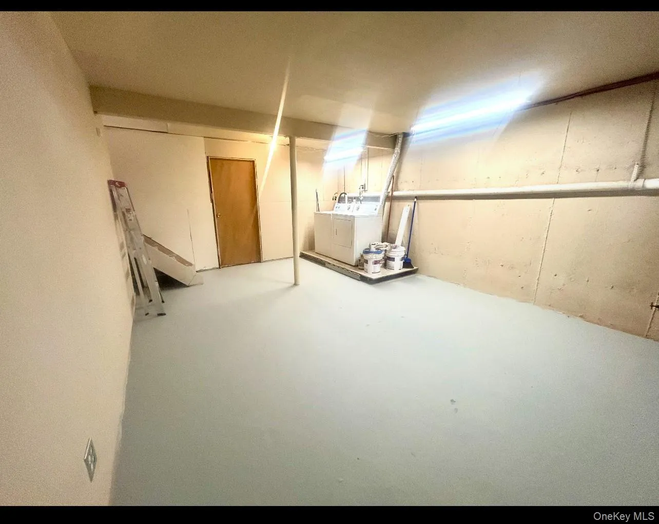 Below grade area with washer and dryer Below grade area with washer and dryer