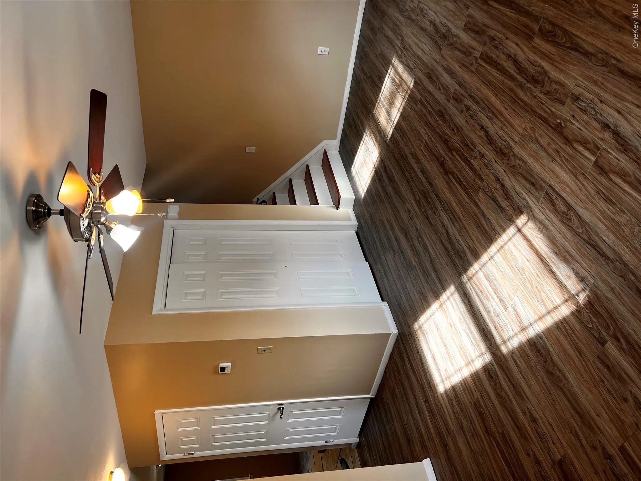 Unfurnished bedroom with dark wood-type flooring, ceiling fan, and a closet Unfurnished bedroom with dark wood-type flooring, ceiling fan, and a closet