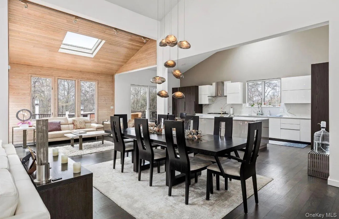 Vaulted wood-paneled ceiling with skylight and dark wood-finish flooring Vaulted wood-paneled ceiling with skylight and dark wood-finish flooring