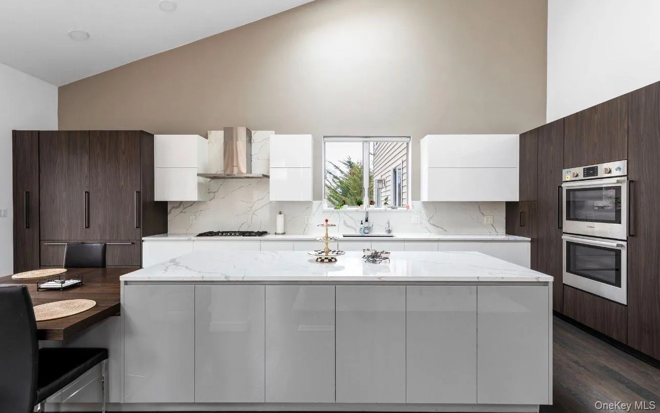 Modern kitchen featuring a vaulted ceiling and recessed lighting Modern kitchen featuring a vaulted ceiling and recessed lighting
