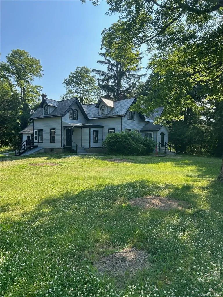 View of front of home featuring a rural view and a front lawn View of front of home featuring a rural view and a front lawn