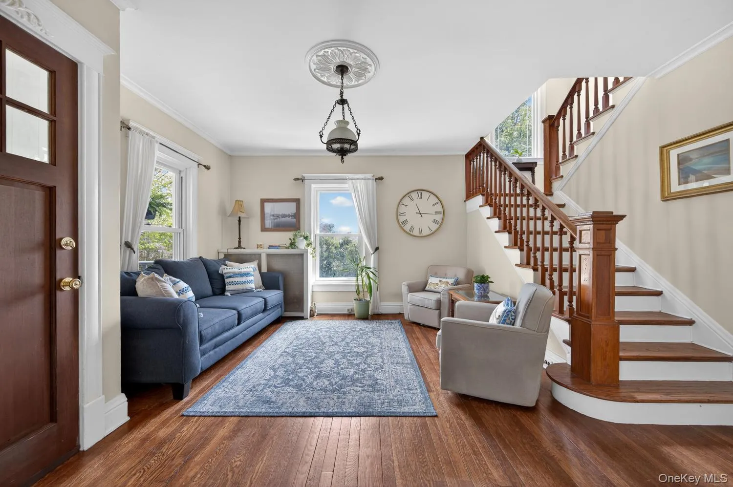 Living room with original staircase Living room with original staircase