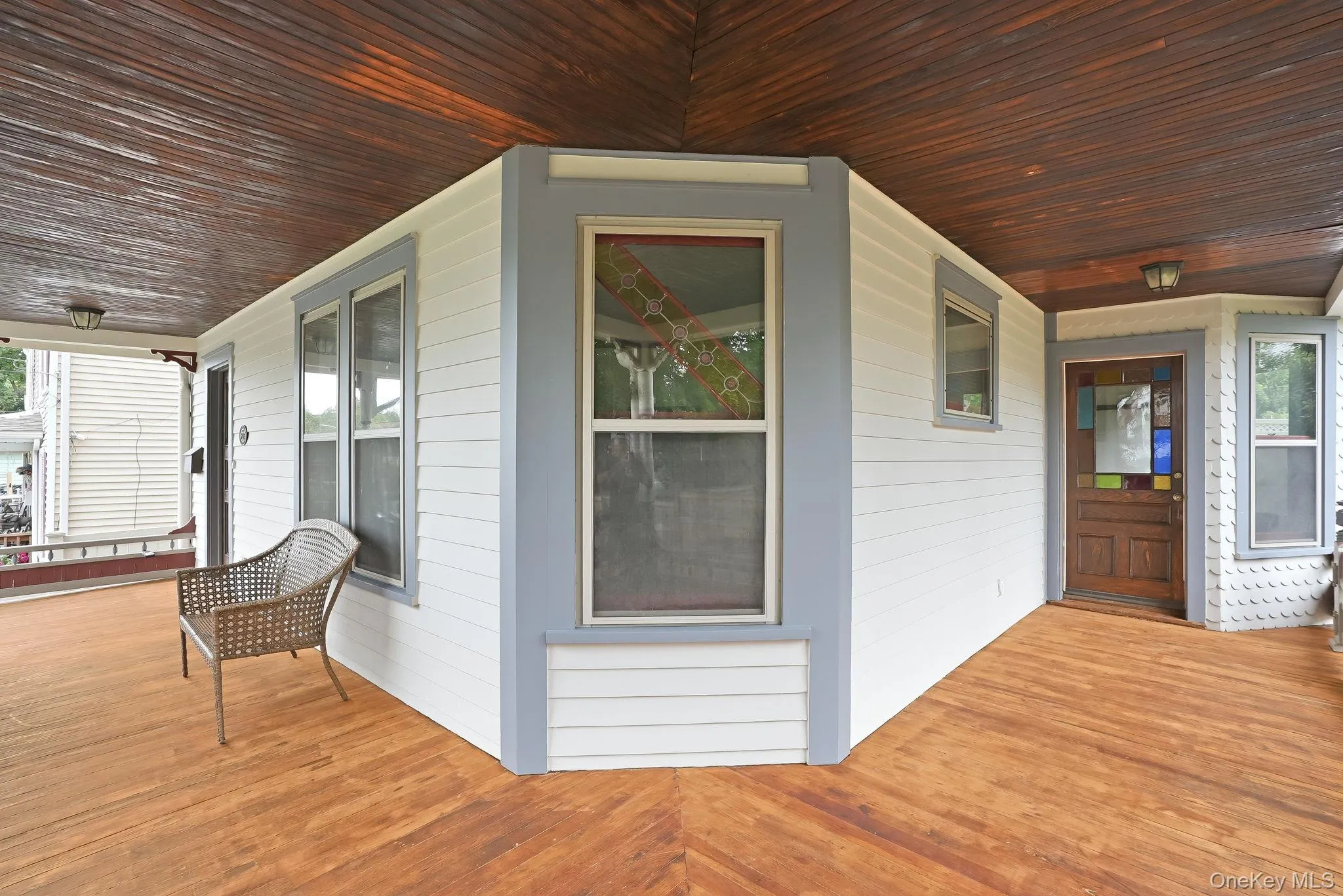wrap around porch, door on right goes to dining room.Stunning original stained glass. wrap around porch, door on right goes to dining room.Stunning original stained glass.