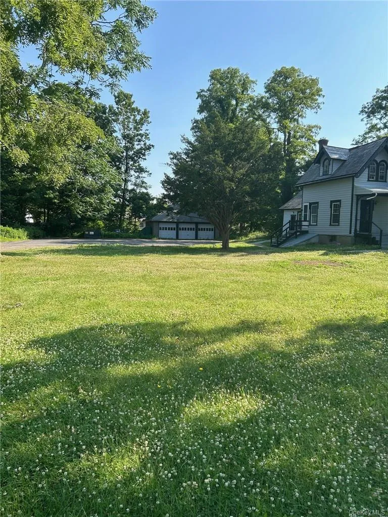 View of yard with a garage View of yard with a garage