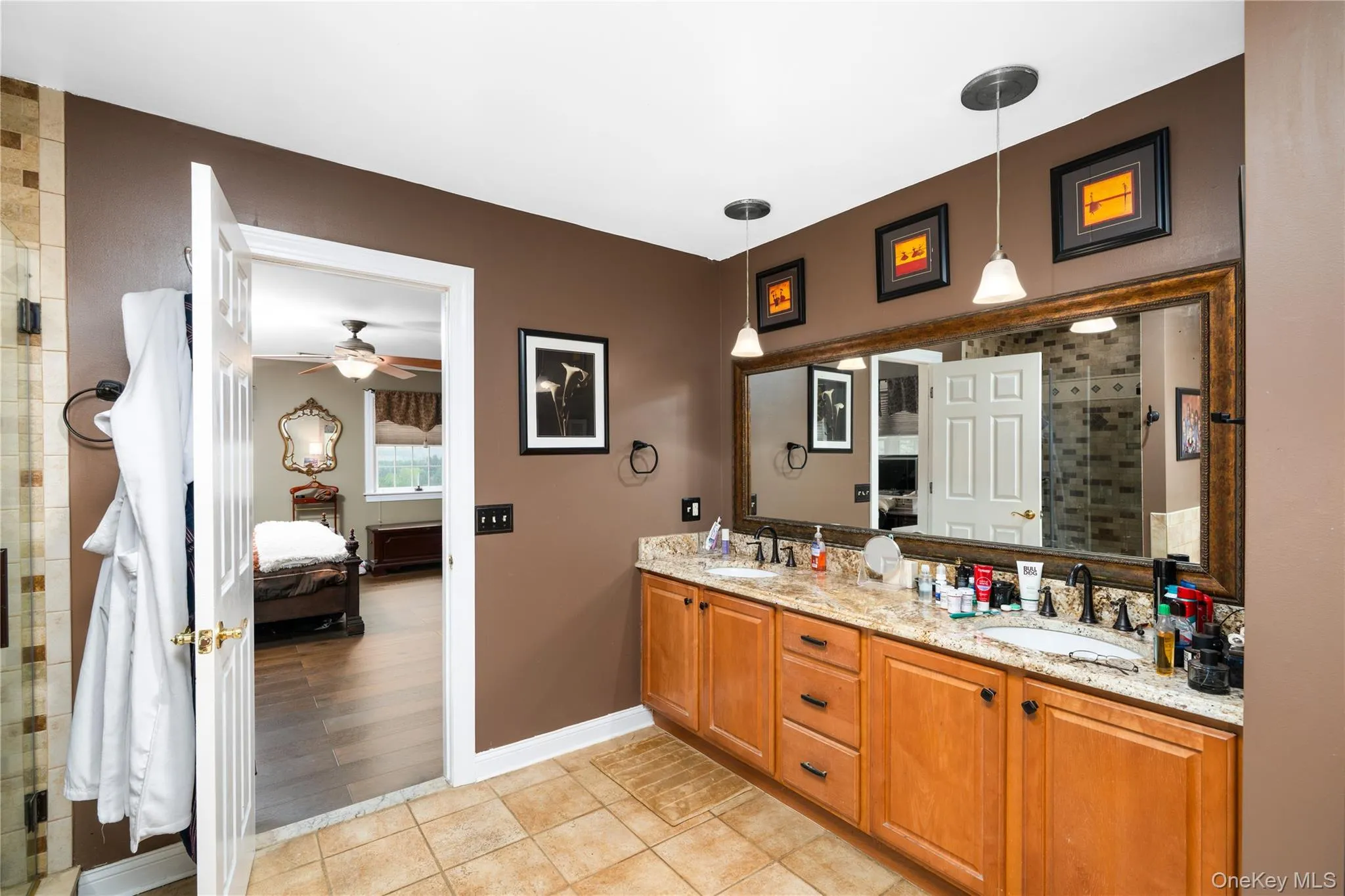 Bathroom featuring a double vanity with granite countertops, dual undermount sinks, and bronze-finish faucets Bathroom featuring a double vanity with granite countertops, dual undermount sinks, and bronze-finish faucets