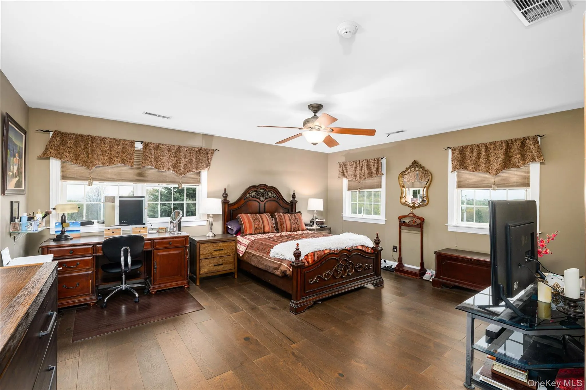 Spacious interior room featuring wood-finish flooring and light-toned walls Spacious interior room featuring wood-finish flooring and light-toned walls