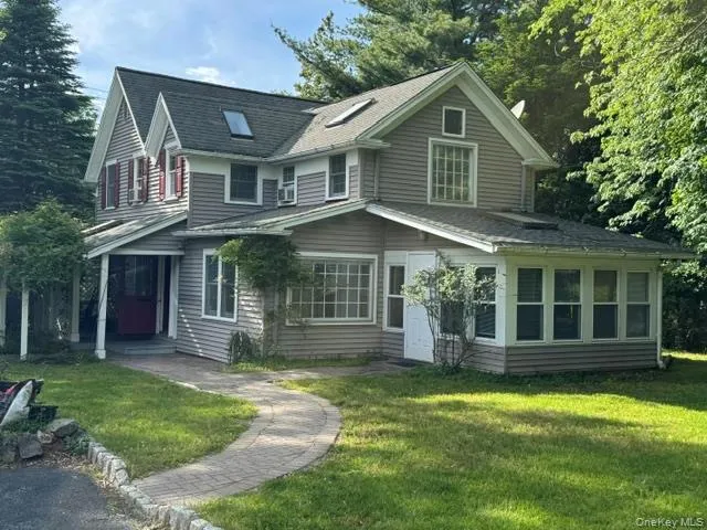 Multi-level residence featuring gray siding and a varied roofline Multi-level residence featuring gray siding and a varied roofline