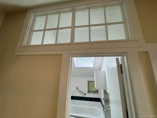 Transom window above a doorway featuring white trim Transom window above a doorway featuring white trim