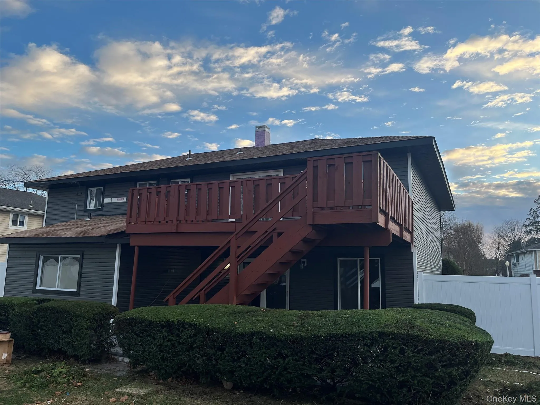 Back of property featuring a wooden deck Back of property featuring a wooden deck
