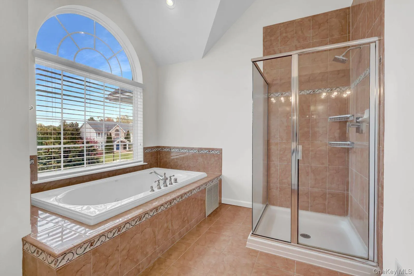 Primary Bathroom with a Soaking Tub and Glass Enclosed Shower Primary Bathroom with a Soaking Tub and Glass Enclosed Shower