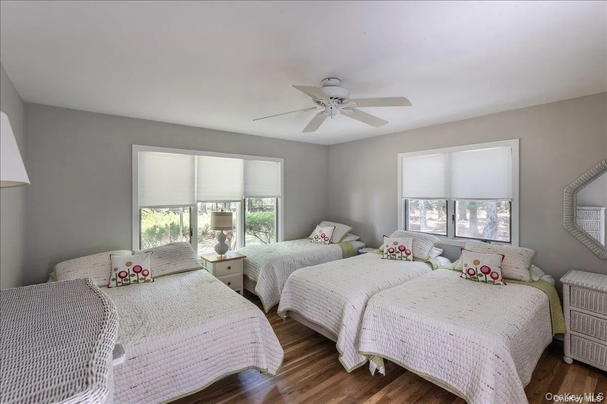 Bedroom featuring wood-finish flooring and neutral wall tones Bedroom featuring wood-finish flooring and neutral wall tones