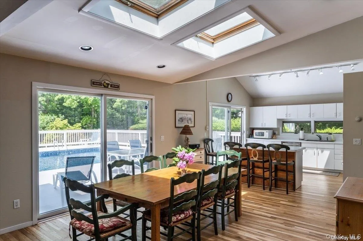 Vaulted ceilings featuring two skylights, recessed lighting, and wood-finish flooring Vaulted ceilings featuring two skylights, recessed lighting, and wood-finish flooring