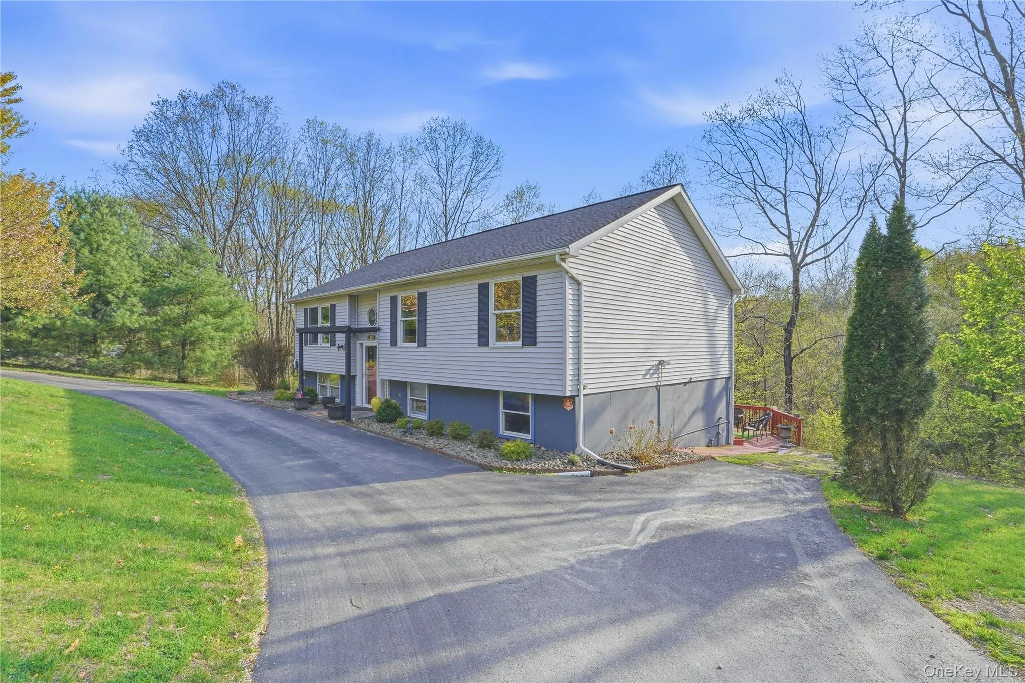 The side view of this raised ranch highlights its classic split-level design, with the upper main living area set above the lower level. Clean, horizontal lines give the home a balanced, streamlined look, while evenly spaced windows bring in natural light to both levels. The side view of this raised ranch highlights its classic split-level design, with the upper main living area set above the lower level. Clean, horizontal lines give the home a balanced, streamlined look, while evenly spaced windows bring in natural light to both levels.