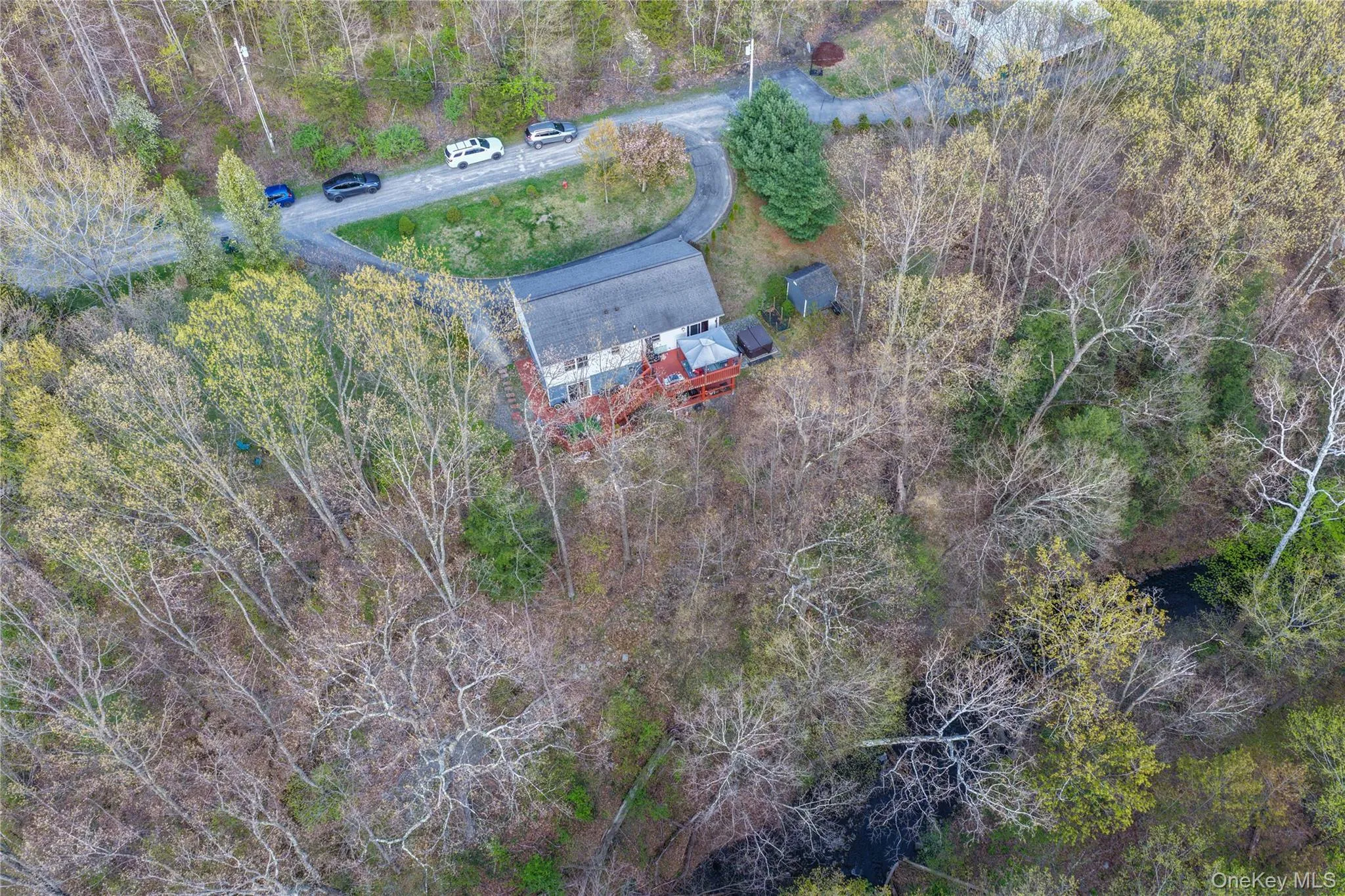Set on a beautiful one-acre lot, this property is surrounded by mature trees that create a peaceful, private setting. A gentle creek winds through the landscape, adding a serene, natural focal point and the soothing sound of flowing water. T Set on a beautiful one-acre lot, this property is surrounded by mature trees that create a peaceful, private setting. A gentle creek winds through the landscape, adding a serene, natural focal point and the soothing sound of flowing water. T