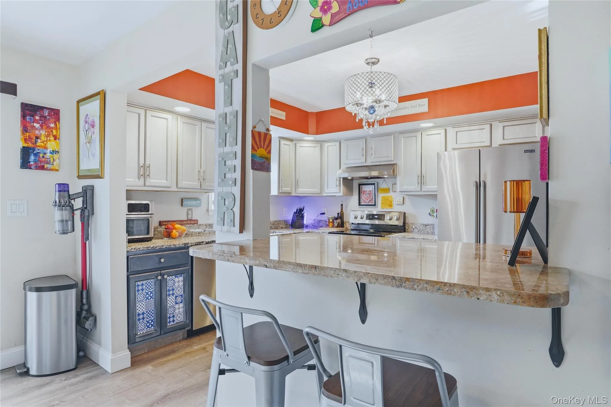 A wide, open pass-through connects the dining room to the kitchen, creating a natural gathering spot that blends style and function. The opening is framed like a casual breakfast bar, with a sleek countertop that extends into the dining space and offers seating for counter stools. It’s the perfect place for morning coffee, quick meals, or chatting with the cook while dinner is being prepared. A wide, open pass-through connects the dining room to the kitchen, creating a natural gathering spot that blends style and function. The opening is framed like a casual breakfast bar, with a sleek countertop that extends into the dining space and offers seating for counter stools. It’s the perfect place for morning coffee, quick meals, or chatting with the cook while dinner is being prepared.