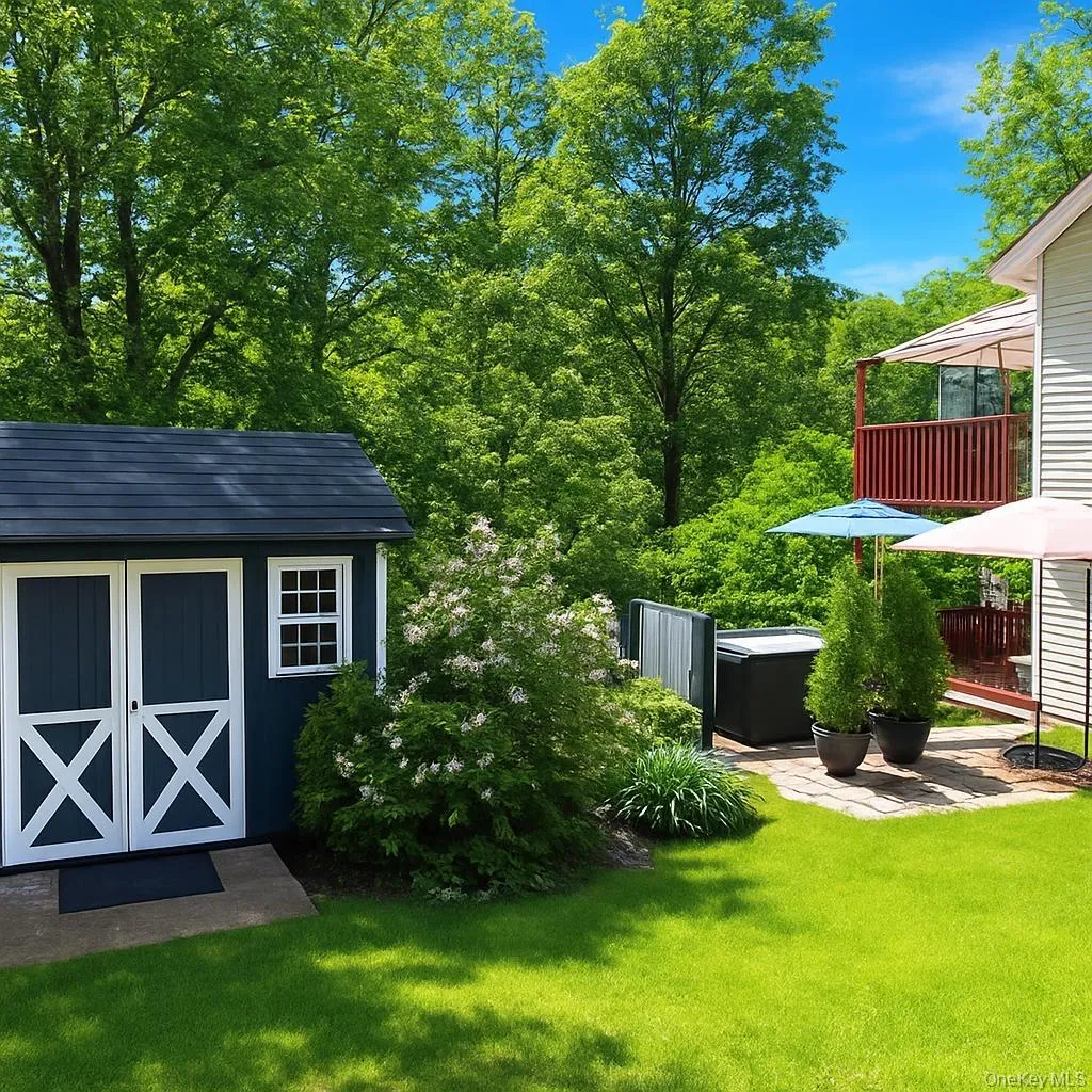 View of backyard, shed and hot tub. View of backyard, shed and hot tub.