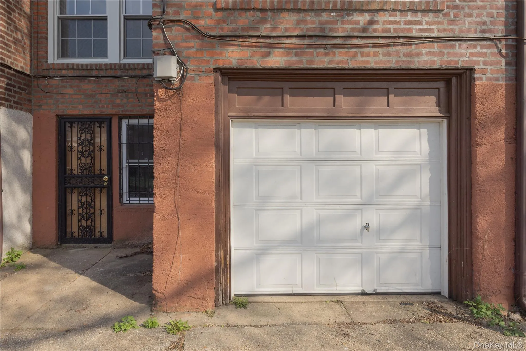 Garage9'1" x 16'3"Single-car garage with a paneled white door, set within a brown frame Garage9'1" x 16'3"Single-car garage with a paneled white door, set within a brown frame