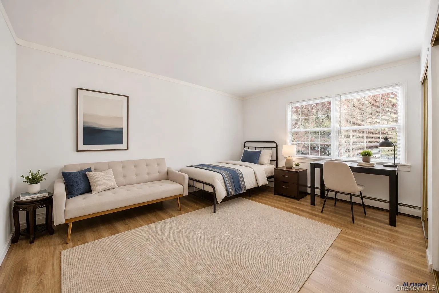 Bright interior room featuring wood-finish flooring and a large window with white trim Bright interior room featuring wood-finish flooring and a large window with white trim