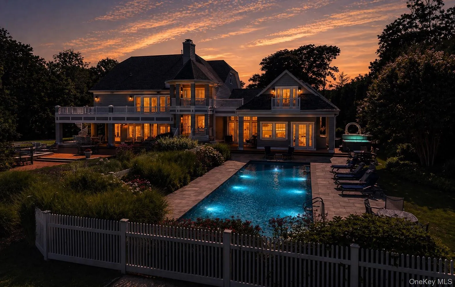 Exterior residence featuring multiple balconies and a large patio Exterior residence featuring multiple balconies and a large patio