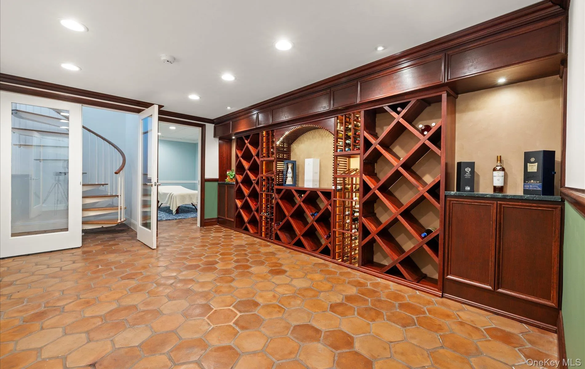 Built-in wine storage system with mahogany-toned cabinetry and integrated lighting Built-in wine storage system with mahogany-toned cabinetry and integrated lighting