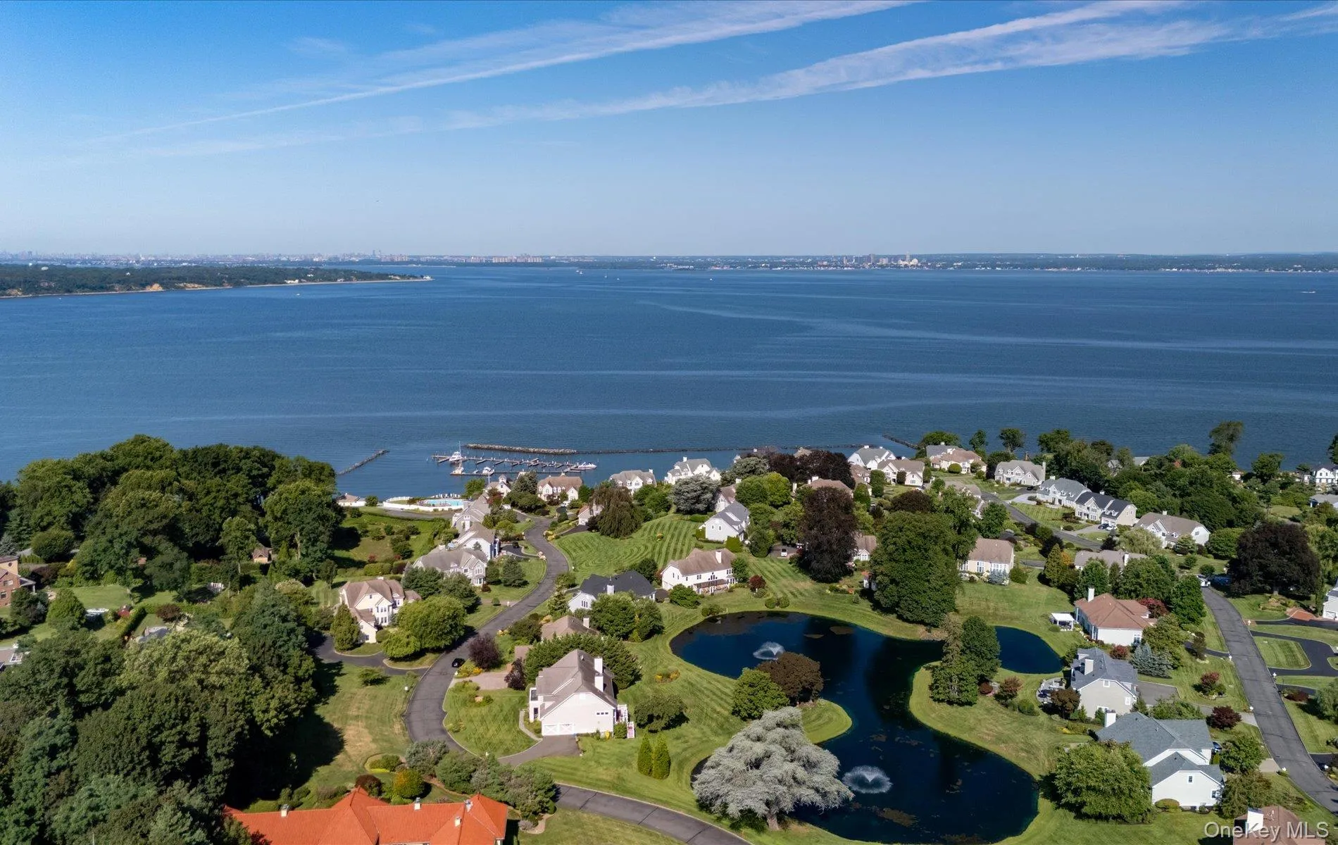 Expansive waterfront community featuring a marina, winding roads, mature landscaping, and multiple residences Expansive waterfront community featuring a marina, winding roads, mature landscaping, and multiple residences