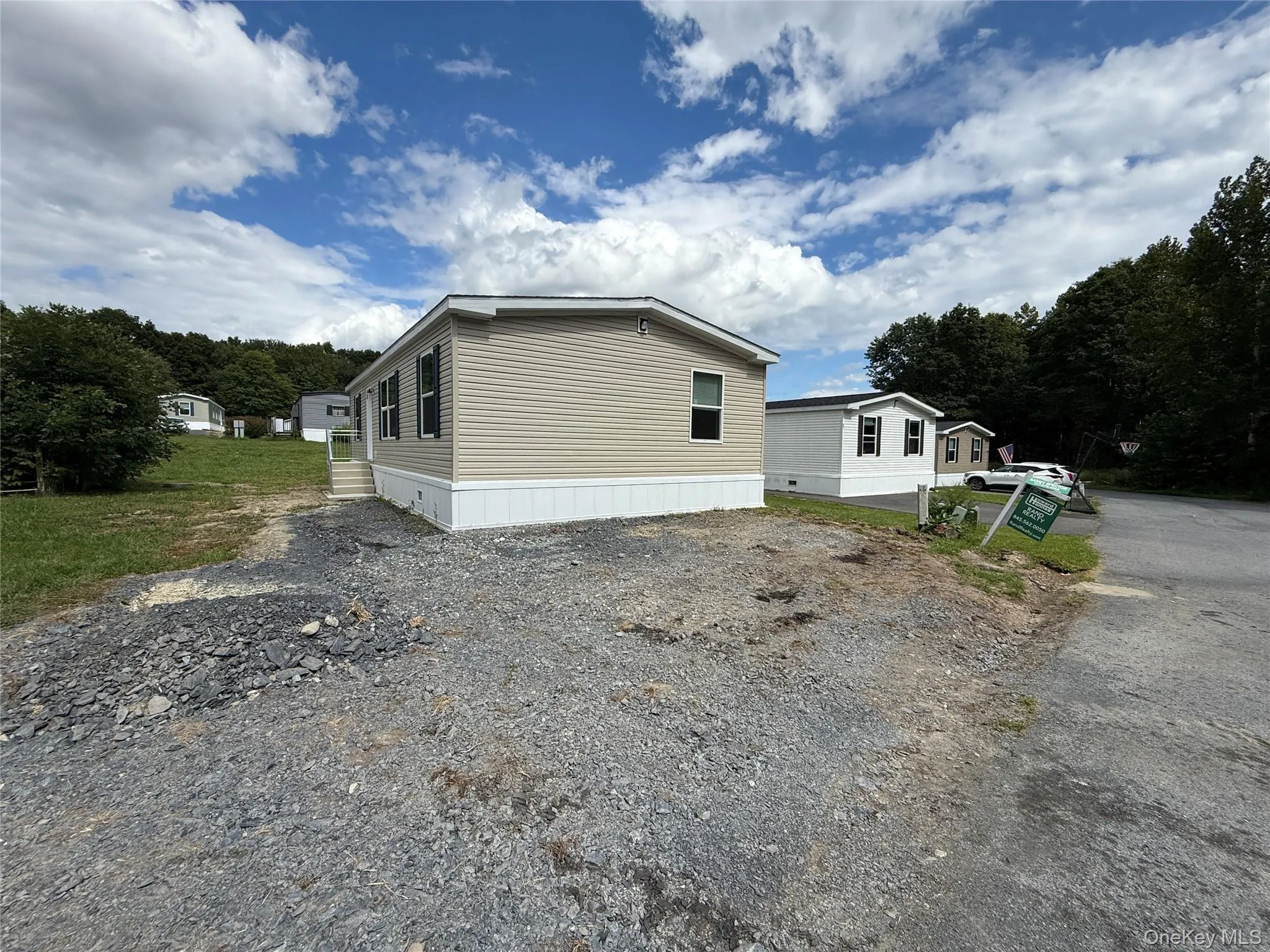View of side of home with gravel driveway View of side of home with gravel driveway