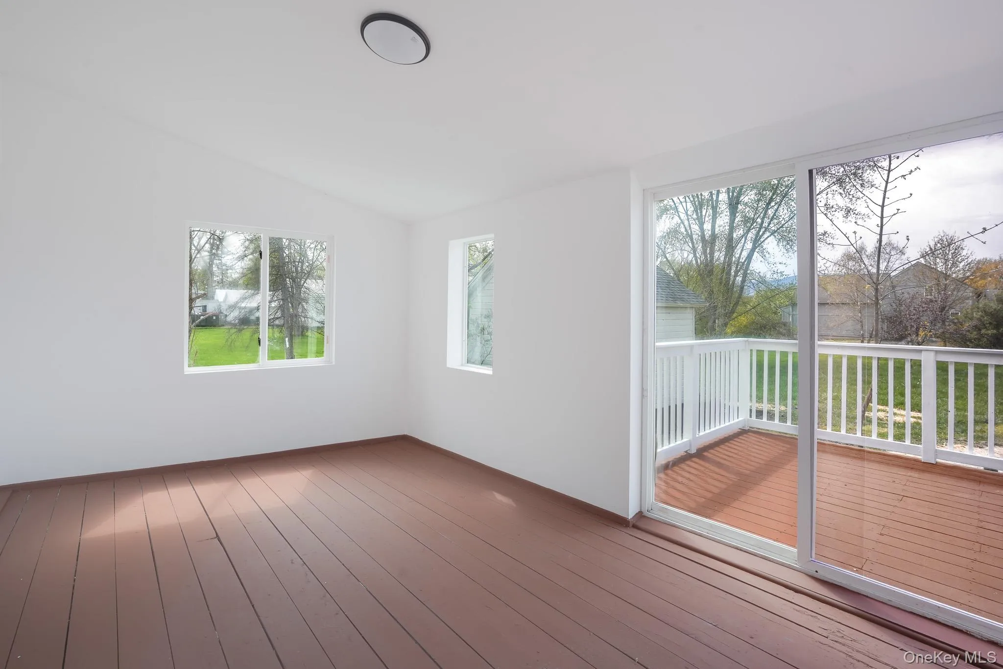 Enclosed sun room leading to the deck. Enclosed sun room leading to the deck.