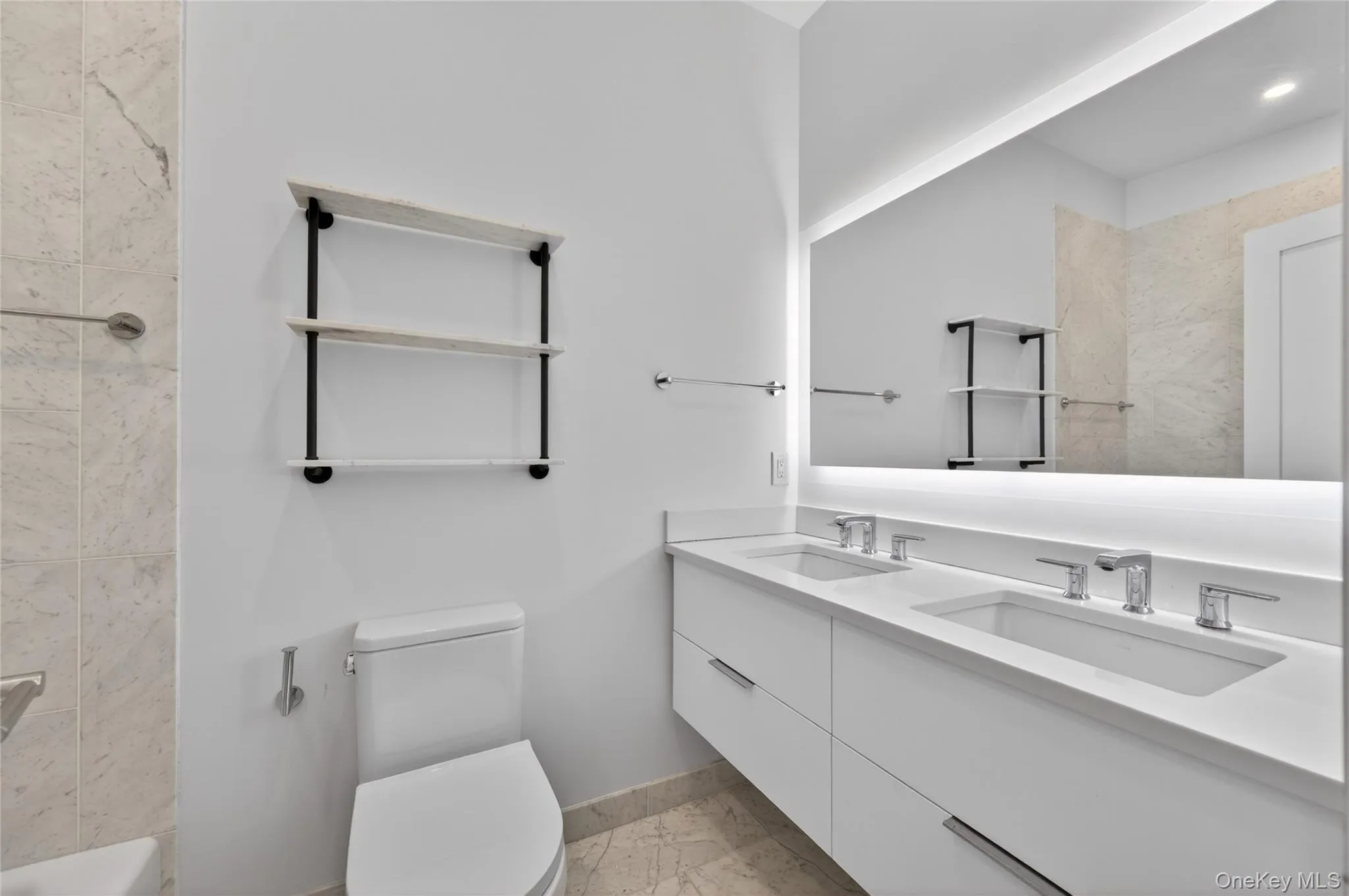 Floating double vanity with integrated sinks and chrome fixtures Floating double vanity with integrated sinks and chrome fixtures