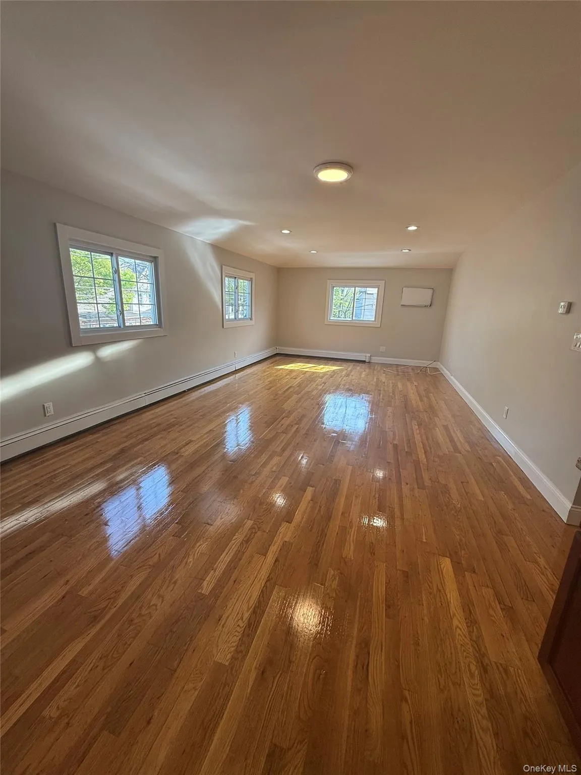 Expansive interior space featuring polished wood flooring Expansive interior space featuring polished wood flooring