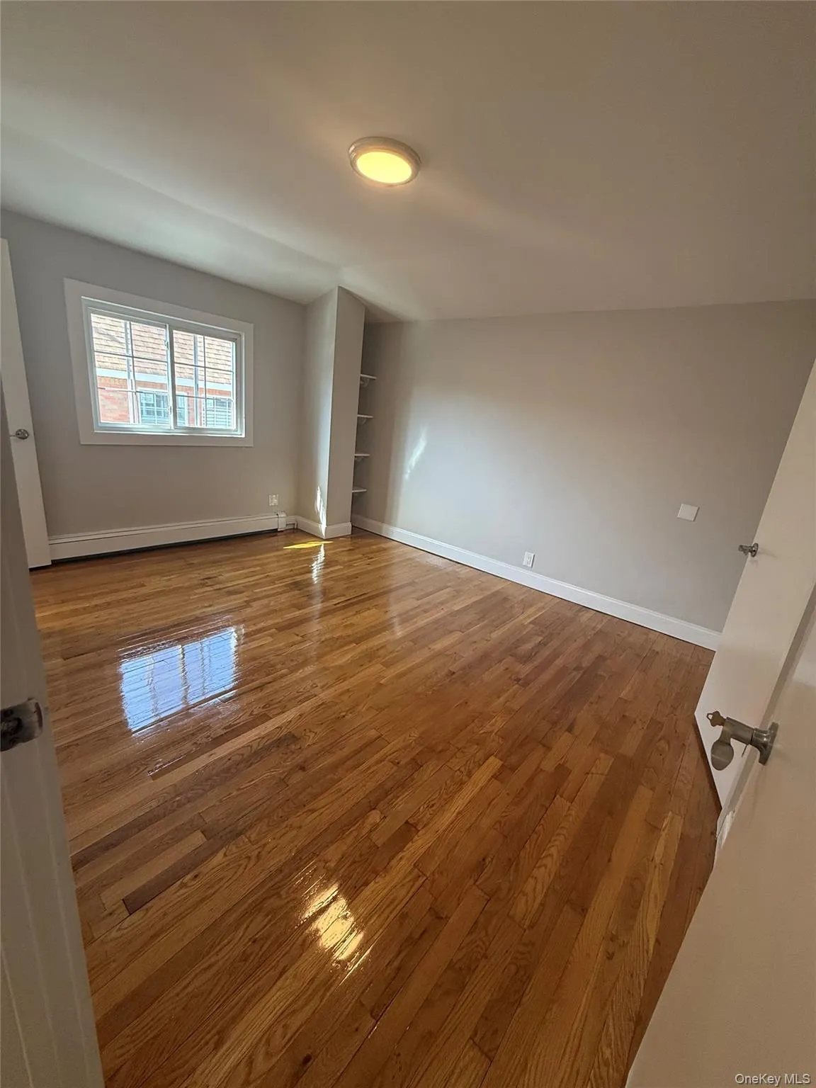 Hardwood flooring and light neutral wall colors characterize this room Hardwood flooring and light neutral wall colors characterize this room