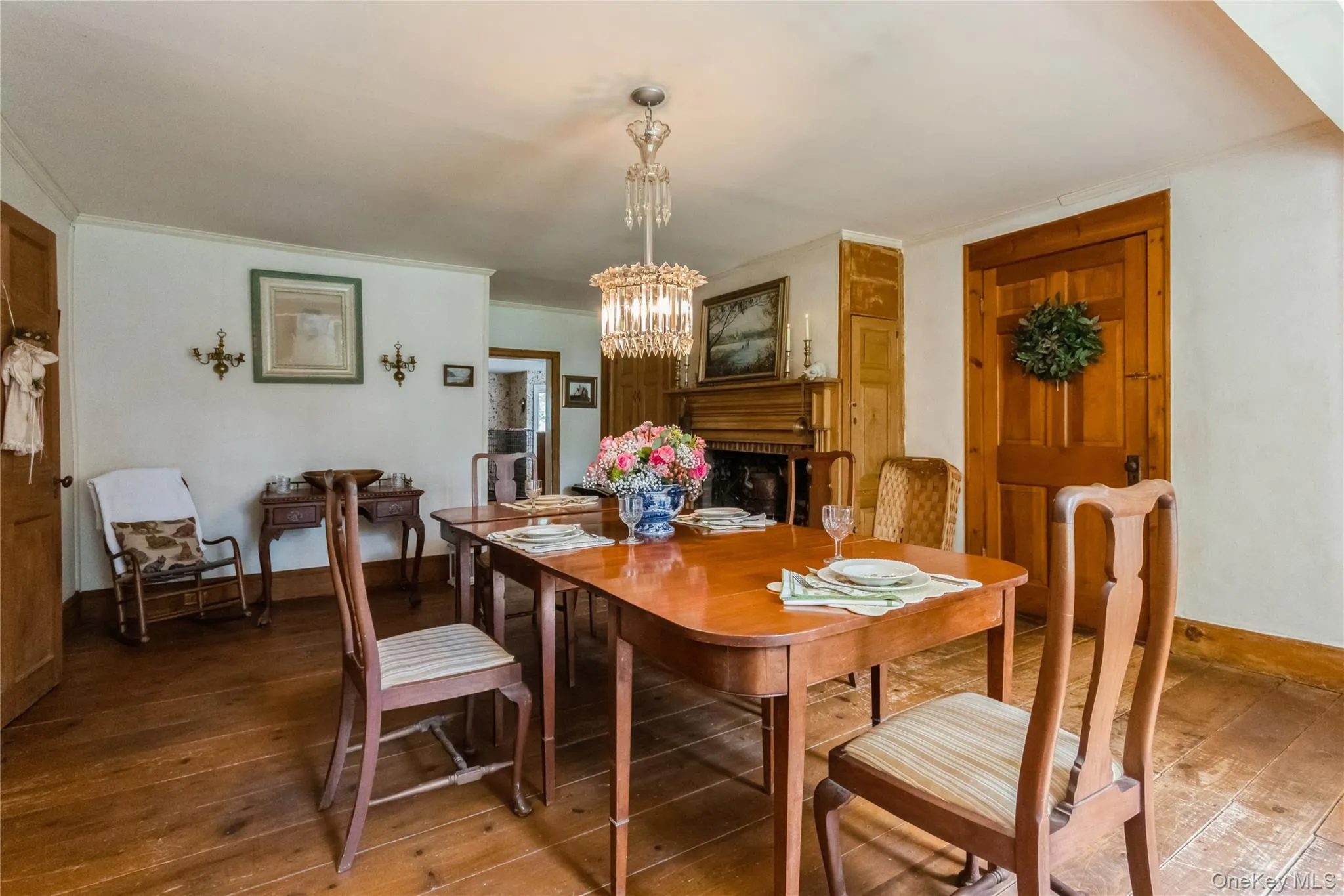 Dining area with fireplace, china cabinets, chandelier, wide board flrs. Dining area with fireplace, china cabinets, chandelier, wide board flrs.