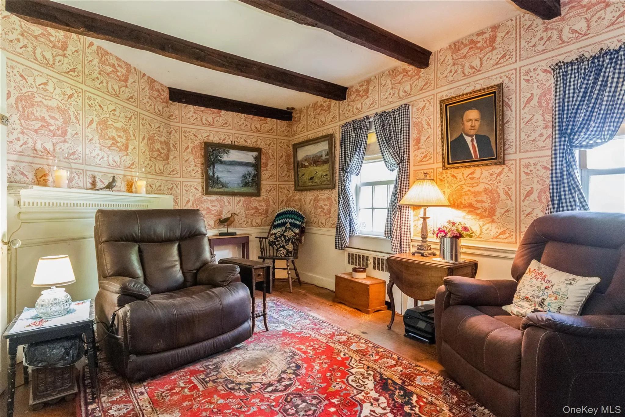 Library, wallpapered walls, beam ceiling, and wide board floors Library, wallpapered walls, beam ceiling, and wide board floors