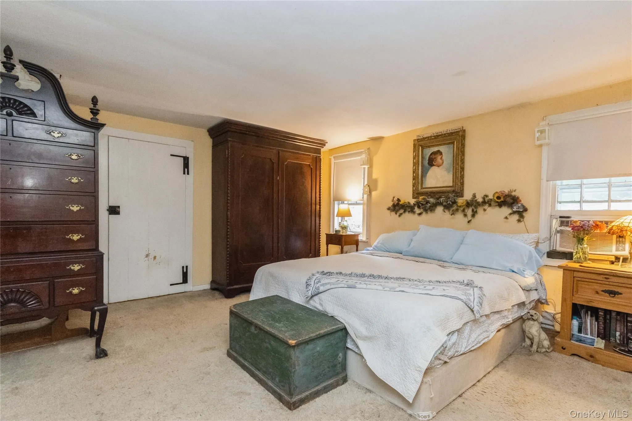 Original Primary Bedroom featuring light colored carpet over Wide Board Flrs. WIC Original Primary Bedroom featuring light colored carpet over Wide Board Flrs. WIC