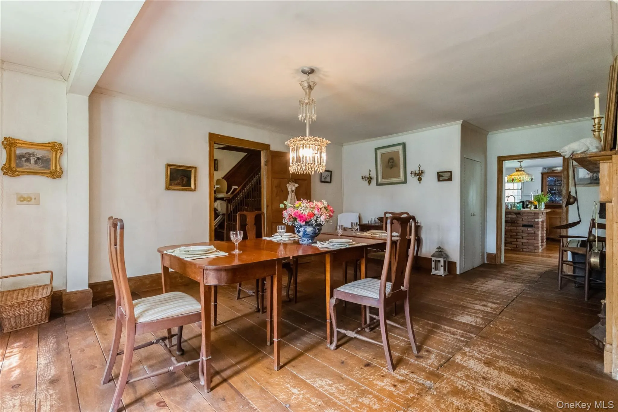 Dining room with a chandelier, wide board flrs.,entrance from kitchen Dining room with a chandelier, wide board flrs.,entrance from kitchen
