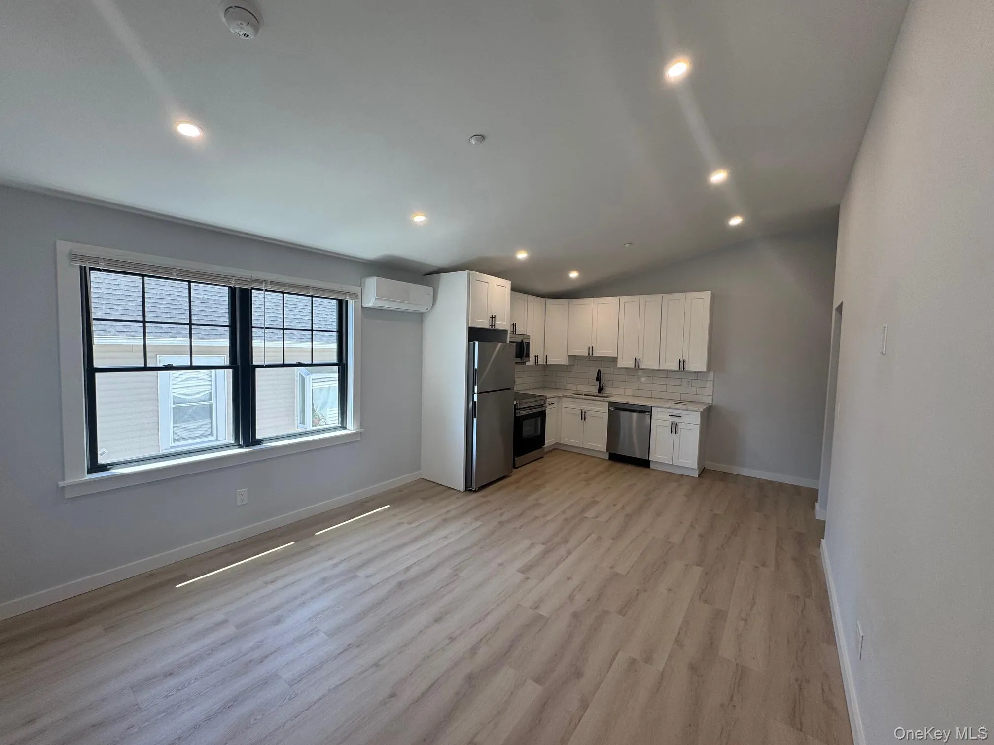 Living room and kitchen with high vaulted ceilings Living room and kitchen with high vaulted ceilings