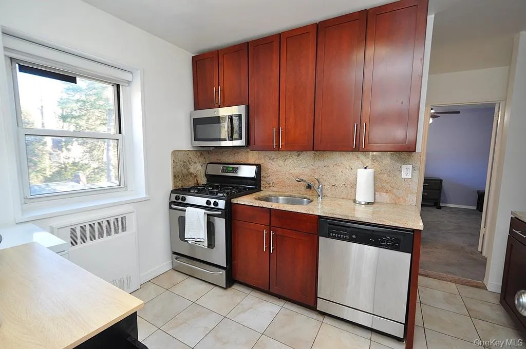 Renovated eat-in-Kitchen has Granite counters, 48" rosewood cabinets and Stainless Steel Appliances including a Dishwasher, microwave, range and refrigerator. Renovated eat-in-Kitchen has Granite counters, 48" rosewood cabinets and Stainless Steel Appliances including a Dishwasher, microwave, range and refrigerator.