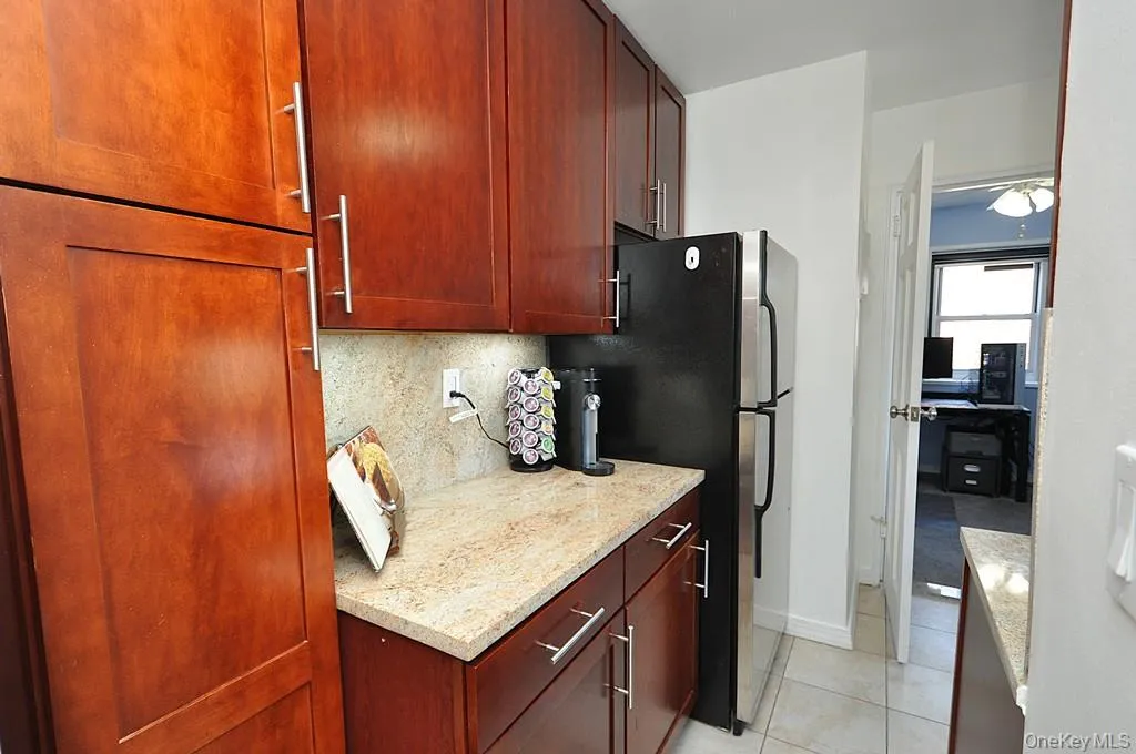 Renovated eat-in-Kitchen has Granite counters, 48" rosewood cabinets and Stainless Steel Appliances including a Dishwasher, microwave, range and refrigerator. Renovated eat-in-Kitchen has Granite counters, 48" rosewood cabinets and Stainless Steel Appliances including a Dishwasher, microwave, range and refrigerator.