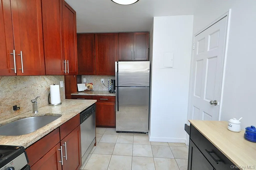 Renovated eat-in-Kitchen has Granite counters, 48" rosewood cabinets and Stainless Steel Appliances including a Dishwasher, microwave, range and refrigerator. Renovated eat-in-Kitchen has Granite counters, 48" rosewood cabinets and Stainless Steel Appliances including a Dishwasher, microwave, range and refrigerator.